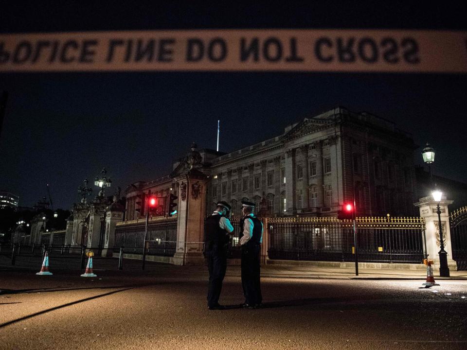 Police officers stand guard at a police cordon next to Buckingham Palace following an incident on 25 August: AFP