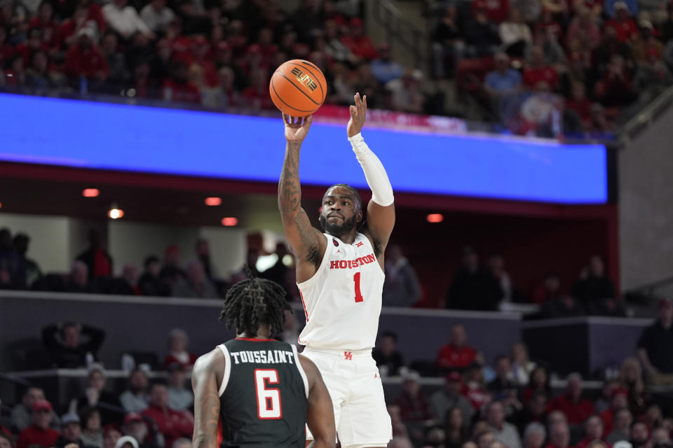 Houston's Jamal Shead (1) shoots as Texas Tech's Joe Toussaint (6) defends during the second half of an NCAA college basketball game Wednesday, Jan. 17, 2024, in Houston. (AP Photo/David J. Phillip)