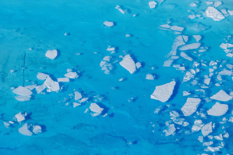 mFILE PHOTO: Chunks of ice float inside of meltwater pools on top of the Helheim glacier near Tasiilaq, Greenland