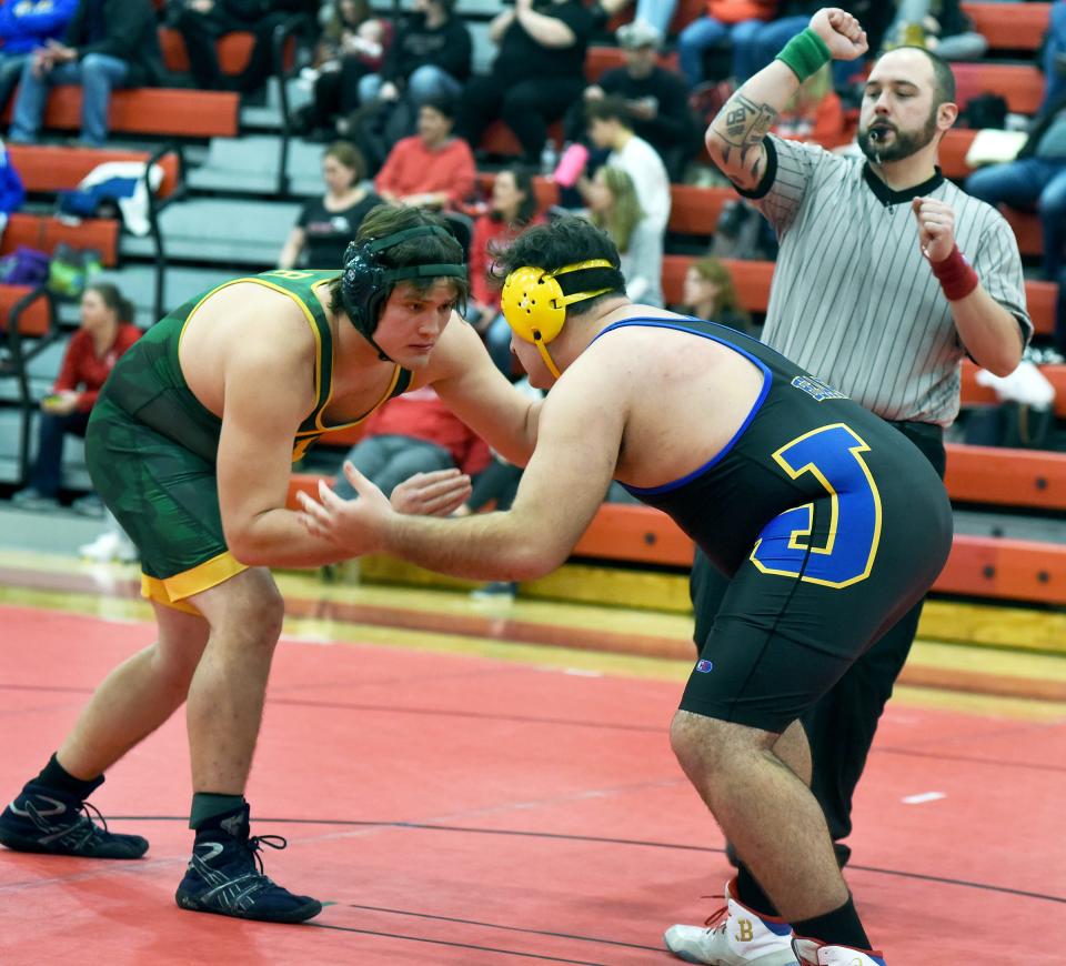 Joseph Siniarski of Flat Rock stares down Freddie Martin of Jefferson in the 285 pound match going onto pin him for the Huron League Championship at Milan Saturday, February 5, 2022.