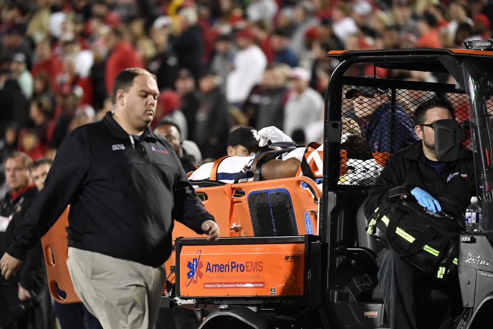 Virginia running back Perris Jones (2) is taken off the field following an injury during the second half of an NCAA college football game against Louisville in Louisville, Ky., Thursday, Nov. 9, 2023. (AP Photo/Timothy D. Easley)