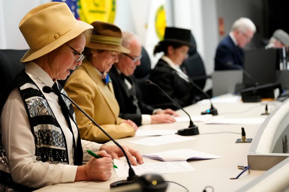 Pam Coles (left) portrays Fair Lawn's first borough clerk, Jasper Van Hook, during a reenactment of the town's first council meeting in 1924. Next to her is state Assemblywoman Lisa Swain, sitting in as councilman Garret Houtsma.
