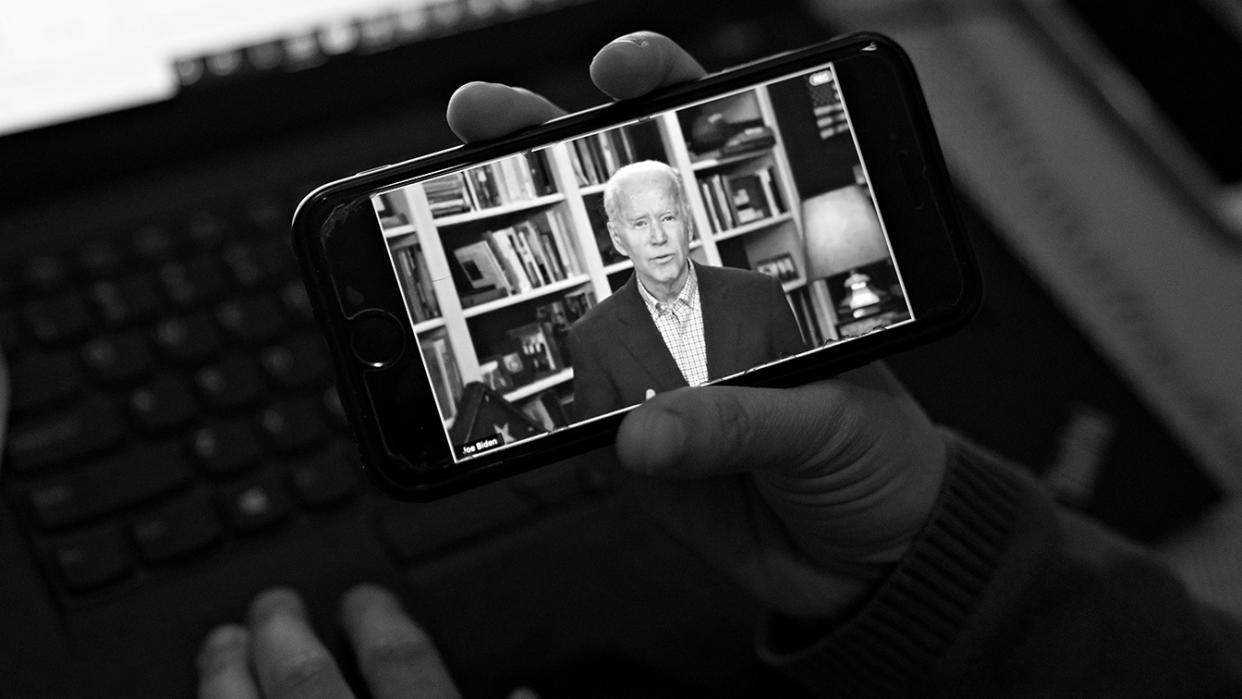 Former Vice President Joe Biden, 2020 Democratic presidential candidate, speaks during a virtual press briefing on a smartphone in this arranged photograph in Arlington, Virginia, U.S., on Wednesday, March 25, 2020. (Andrew Harrer/Bloomberg via Getty Images)