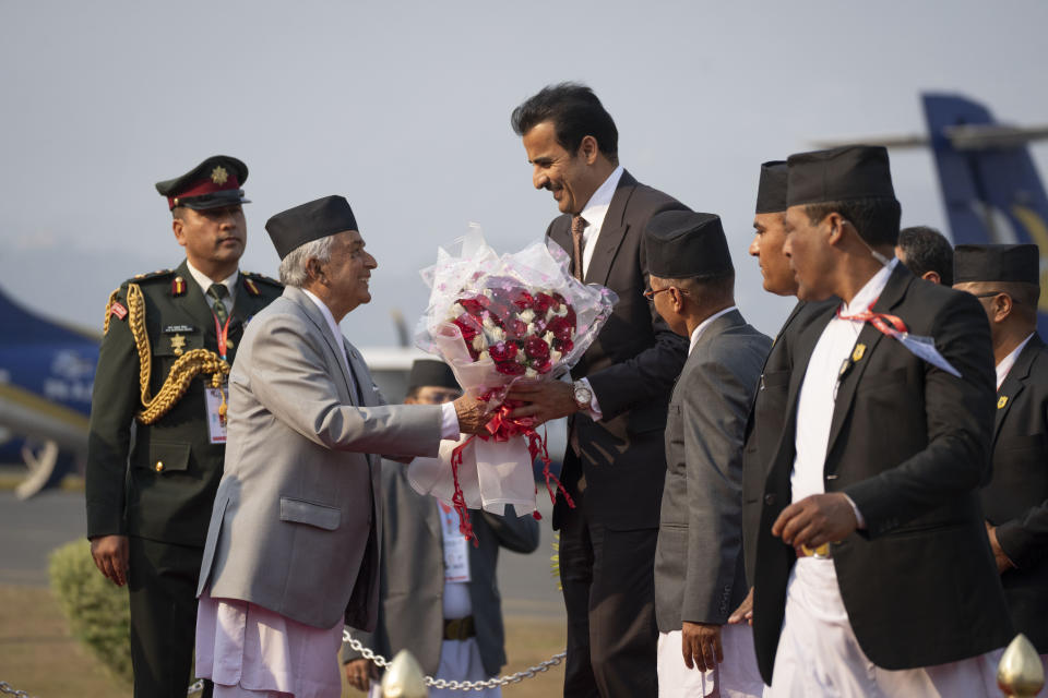 Qatar's Emir Sheikh Tamim bin Hamad Al Thani, is received by Nepal President Ram Chandra Poudel, left as he arrives at the airport in Kathmandu, Nepal, Tuesday, April 23, 2024. The emir is on a two-days visit to the Himalayan nation. (AP Photo/Niranjan Shreshta)