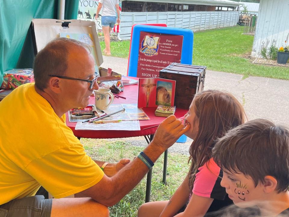 Penny and Benjamin McNutt came to the Crawford County Fair on Monday with their mom, Denise McNutt, and enjoyed having their faces painted by Dale Baer of Child Evangelical Fellowship.