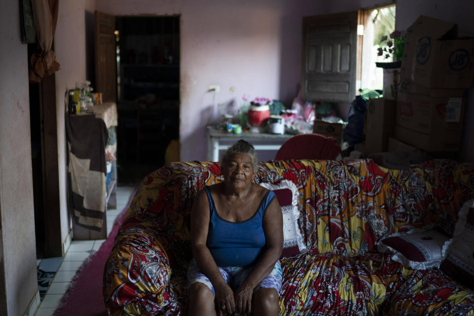 In this Nov. 28, 2019 photo, Domingas Rufina, a member of the local women's association, poses in her home in Trairao, Para state, Brazil. The 67-year-old is considering a move to another quiet town after a leader of her association was threatened for denouncing the illegal logging in the nearby Trairao national forest. Rufina doesn't want to get mixed up in any conflict. "I don't know how to read and I only know how to write my name, but I am an experienced woman," she says. (AP Photo/Leo Correa)