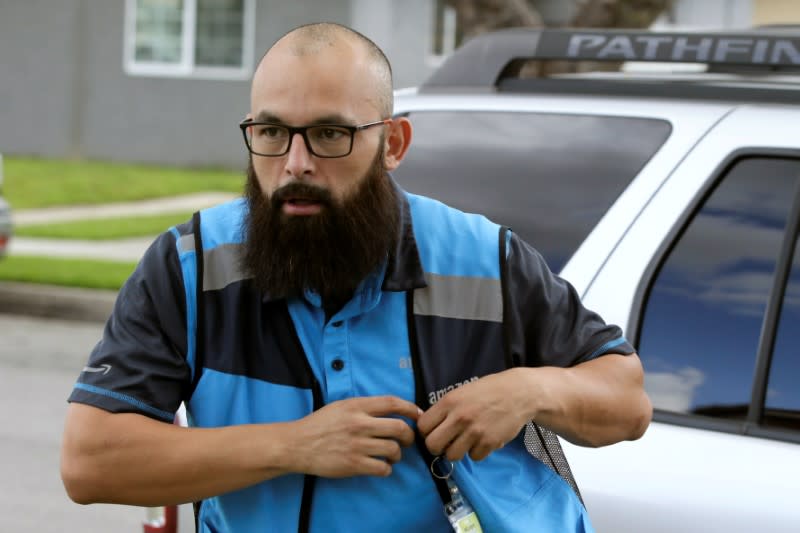 Danny Gonzalez puts on his vest when he makes deliveries for Amazon during the outbreak of the coronavirus disease