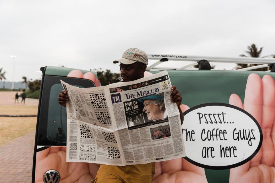 A man catches up on the latest news about the Queen’s passing in Durban (AFP/Getty)