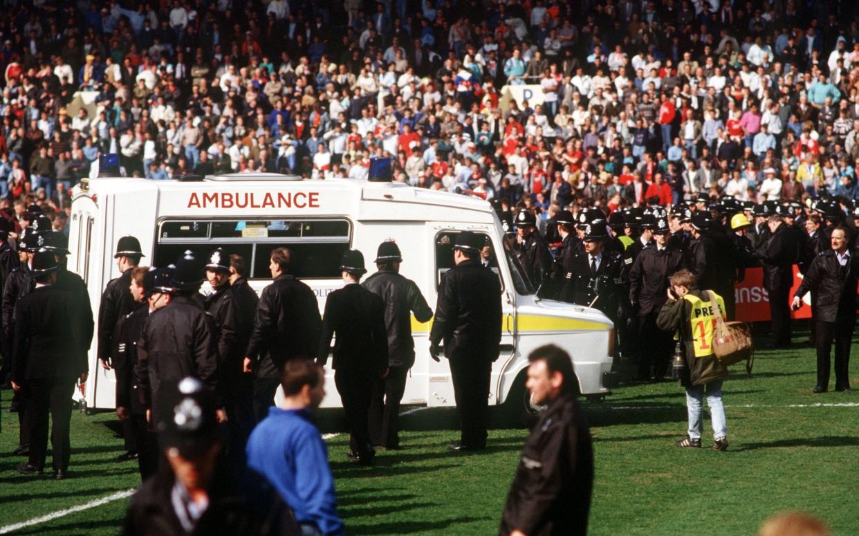 Paramedics and police officers attend the disaster at Hillsborough on April 15, 1989 - Bob Thomas/Getty