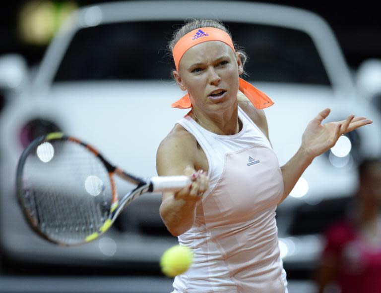 Caroline Wozniacki has set up a third round meeting with Agnieszka Radwanska at the Madrid Open as her promising start to the clay court season continues