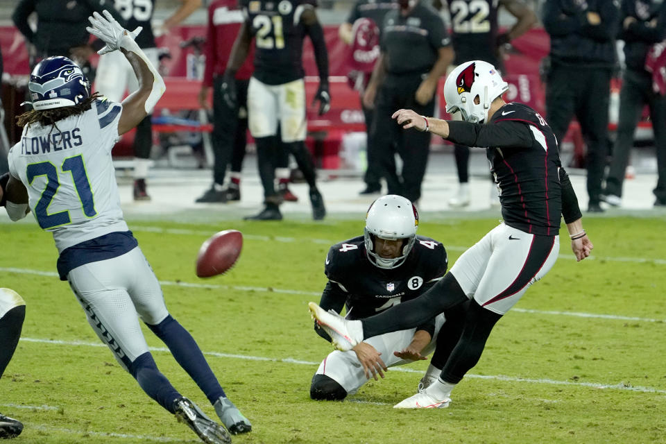 Arizona Cardinals kicker Zane Gonzalez kicks the game winning field goal as punter Andy Lee (4) holds during the second half of an NFL football game against the Seattle Seahawks, Sunday, Oct. 25, 2020, in Glendale, Ariz. The Cardinals won 37-34 in overtime. (AP Photo/Rick Scuteri)