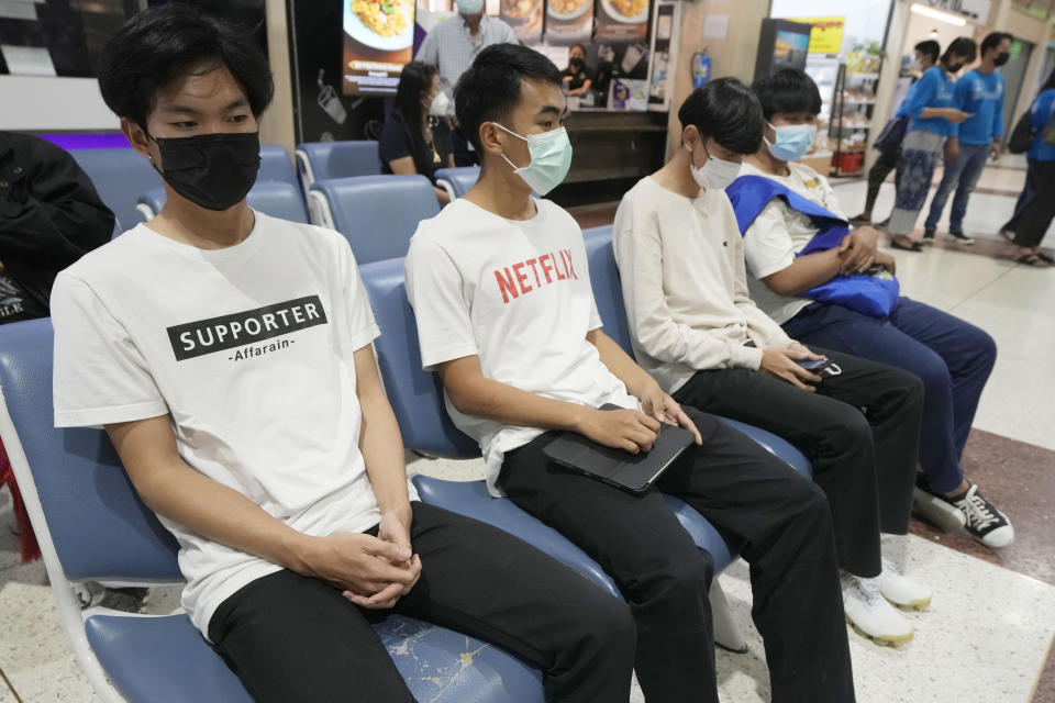 Members of the Wild Boars soccer team who were rescued from a 2018 flooded cave wait for ashes of Duangphet Phromthep at Mae Fah Luang airport in Chiang Rai province Thailand, Saturday, March 4, 2023. The cremated ashes of Duangphet, one of the 12 boys rescued from a flooded cave in 2018, arrived in the far northern Thai province of Chiang Rai on Saturday where final Buddhist rites for his funeral will be held over the next few days following his death in the U.K. (AP Photo/Sakchai Lalit)