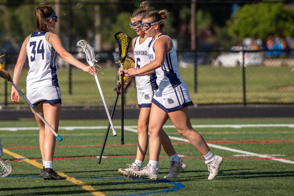 (From left) R#34 Ellie Schmitt, R #6 Maeve Murphy and R #4 Jea Herninko celebrate after scoring a goal. Rutherford girls lacrosse hosts Hoboken on Wednesday, May 17, 2023.
