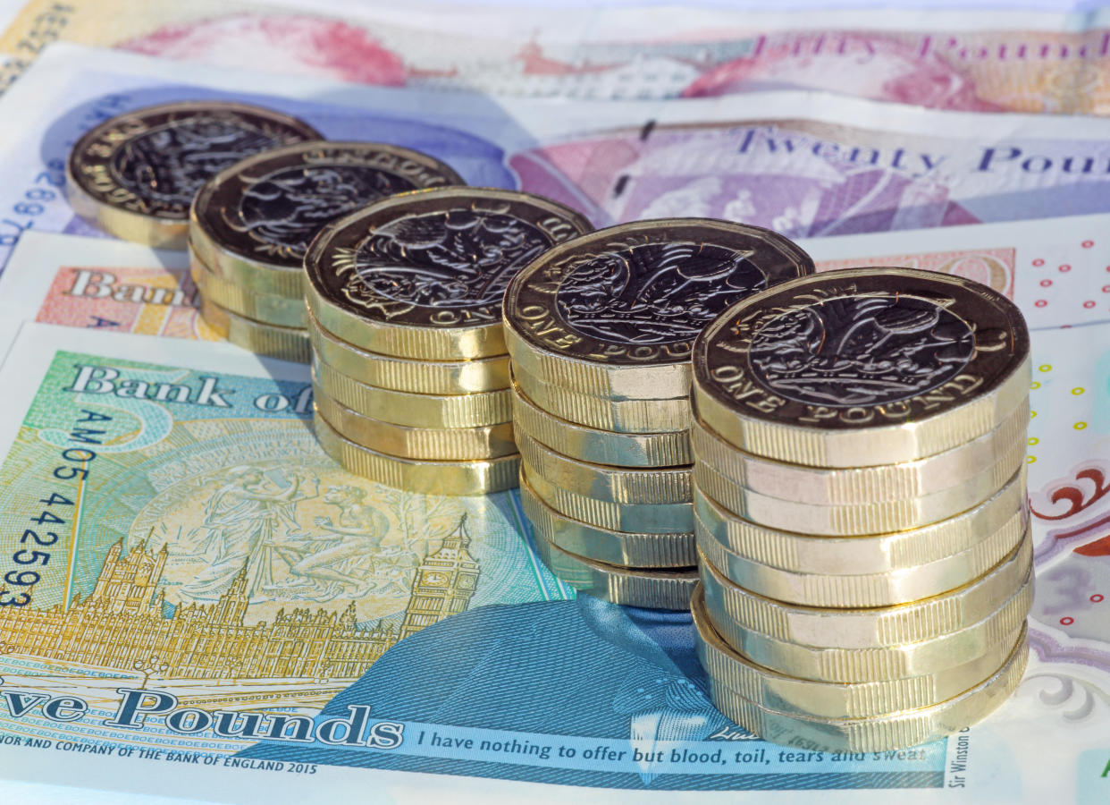 Coins and notes. (Getty)