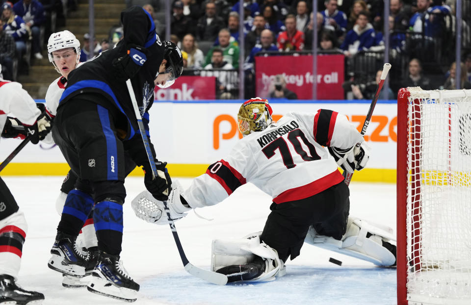 A shot goes wide Ottawa Senators' goaltender Joonas Korpisalo's (70) net as Toronto Maple Leafs' Matthew Knies (23) looks on during the second period of an NHL hockey game, Wednesday, Dec. 27, 2023 in Toronto. (Frank Gunn/The Canadian Press via AP)