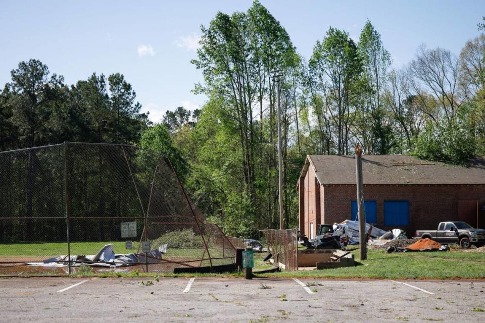 Severe storms last night caused several trees to fall on structures and causing damage on Friday, April 12, 2024. Crews work on removing parts of a tree that fell on the West Rowan YMCA gym behind Mt. Ulla Elementary School.