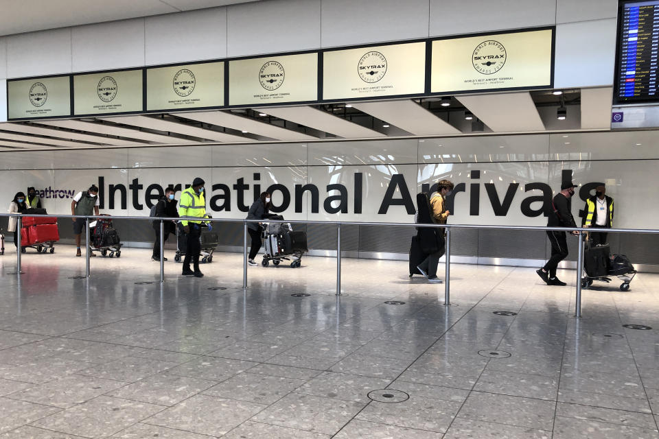 LONDON, ENGLAND - APRIL 23: Passengers are escorted through the arrivals area of terminal 5 towards coaches destined for quarantine hotels, after landing at Heathrow airport on April 23, 2021 in London, England. From 4am this morning, passengers landing in the UK from India are now required to stay in isolation at government-approved hotels for ten days, in a bid to prevent the spread of a new strain of the COVID-19 virus. Indian health services are currently struggling to fight soaring infection rates and a rapidly-rising death toll. (Photo by Leon Neal/Getty Images)