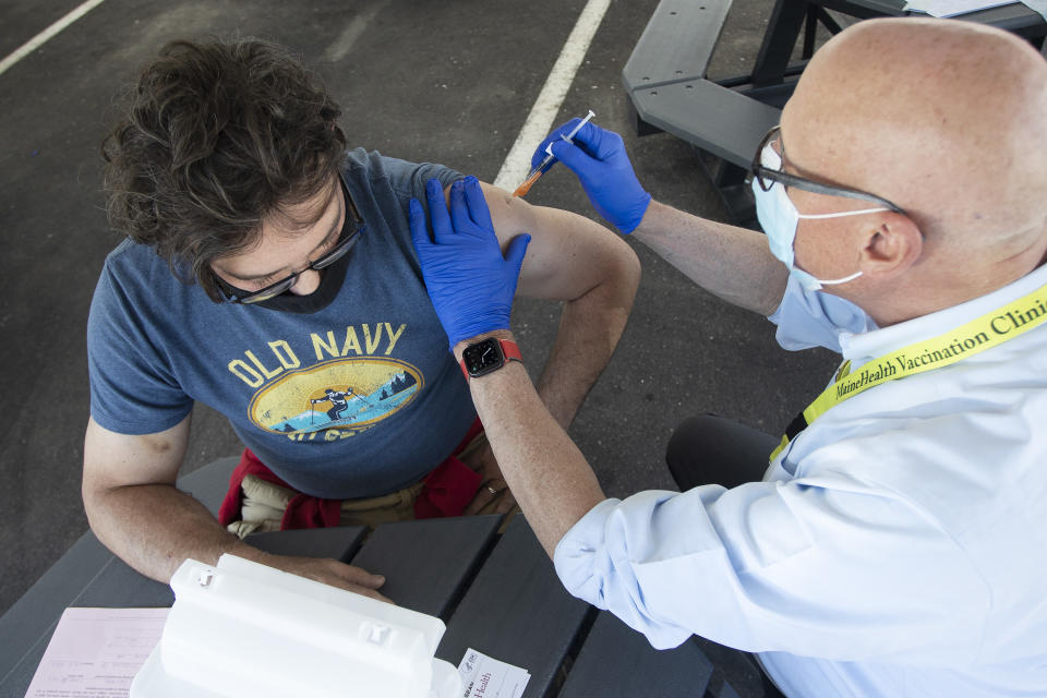 Sean Edwards, 55, of Bridgton, receives a J&J vaccine from retired physician Nat James during a clinic  in Portland, OR. (Derek Davis/Portland Press Herald via Getty Images)