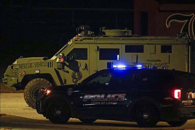 <p>CJ GUNTHER/EPA-EFE/Shutterstock</p> Law enforcement vehicles are parked on the Lisbon High School gymnasium as an active search for the shooter is underway following a mass shooting.