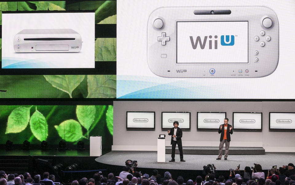 Shigeru Miyamoto, senior manager director of Nintendo Co., Ltd., left, with Bill Trinen, director of product marketing of Treehouse, introduce the Wii U at the Nintendo All-Access presentation at the E3 2012 in Los Angeles Tuesday, June 5, 2012. The Electronic Entertainment Expo runs from June 5-7 in Los Angeles. (AP Photo/Damian Dovarganes)