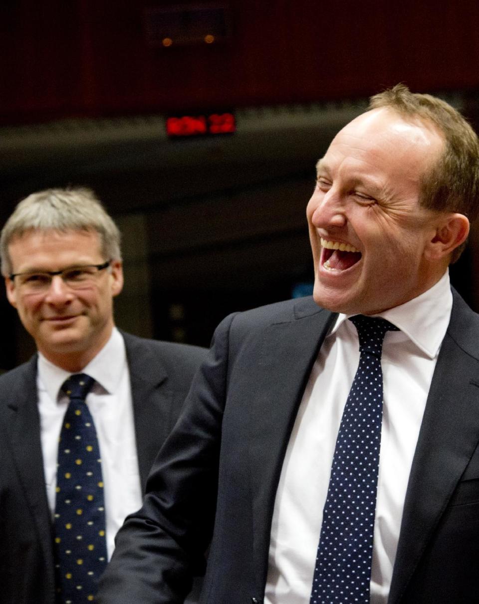 Danish Foreign Minister Martin Lidegaard, right, laughs during a meeting of EU foreign ministers in Brussels on Monday, Feb. 10, 2014. EU foreign ministers on Monday will discuss how to help foster a political situation for the severe crisis that has engulfed Ukraine. The 28 ministers were also weighing the fallout of Sunday’s referendum in Switzerland putting into question the free movement of citizens between the bloc and the Alpine nation. (AP Photo/Virginia Mayo)