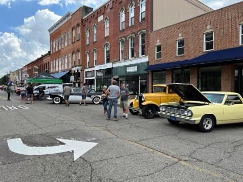Festival goers check out vintage cars entered into Friday's Summer in the City event in downtown Hillsdale.