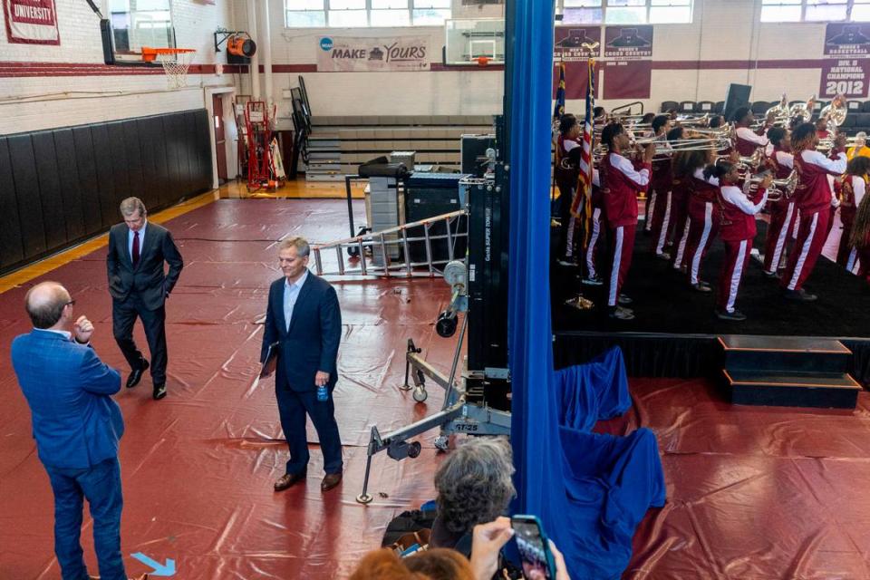 North Carolina Gov. Roy Cooper, top left, and Attorney General Josh Stein, center left, wait backstage with Democratic strategist Morgan Jackson (facing away) at a Stein campaign rally at Shaw University in downtown Raleigh on Tuesday, Oct. 10, 2023.