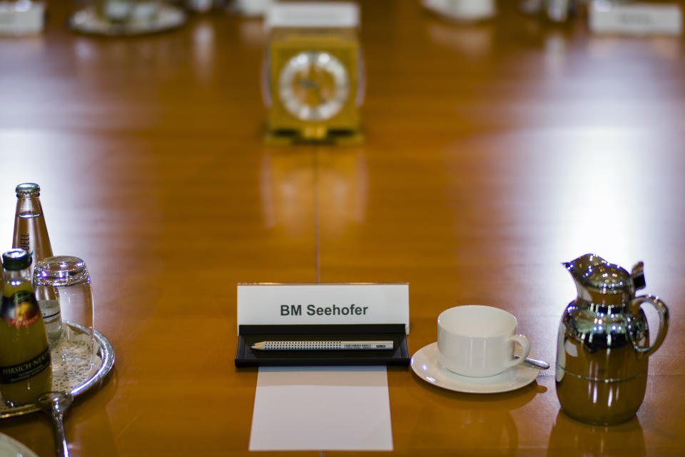 FILE - In this Oct. 17, 2018 file photo shows a name sign marking the place of German Interior Minister Horst Seehofer who did not attend the weekly cabinet meeting of the German government at the chancellery in Berlin. Germany's top security official, who has frequently criticized Chancellor Angela Merkel's migrant policy, is reportedly planning to quit his post in government. German news agency dpa quoted multiple unnamed party officials as saying Horst Seehofer told a meeting of the Christian Social Union on Sunday that he plans to relinquish its leadership and his role as interior minister in Merkel's government. (AP Photo/Markus Schreiber, file)