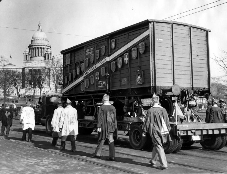 The merci train boxcar, loaded with gifts from the people of France, rides on a trailer in Providence for an acceptance ceremony at the State House in February 1949.