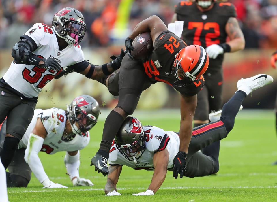 Browns running back Nick Chubb rushes for a first-half first down over Tampa Bay Buccaneers safety Antoine Winfield Jr. (31), Sunday, Nov. 27, 2022, in Cleveland.