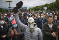 A man, wearing a mask to protect against coronavirus, attends a rally to support for potential presidential candidates in the upcoming presidential elections in Minsk, Belarus, Sunday, May 31, 2020. A human rights group in Belarus says more than 30 people have been detained amid demonstrations against authoritarian President Alexander Lukashenko running for another term. The presidential campaign is underway in Belarus despite the coronavirus outbreak after the parliament and government refused to postpone the election scheduled for August 9. (AP Photo/Sergei Grits)