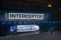 Young Dutch inventor Boyan Slat, right, unveils the Interceptor in Rotterdam, Netherlands, Saturday, Oct. 26, 2019. Slat is taking his effort to clean up floating plastic from the Pacific Ocean to rivers, using the Interceptor, a new floating device to catch garbage before it reaches the seas. (AP Photo/Peter Dejong)