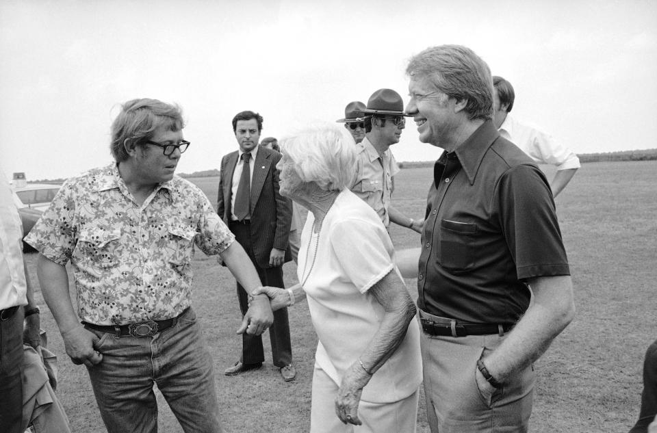 FILE - Billy Carter, left, mother Lillian Carter and President Jimmy Carter enjoy a family joke prior to the president's departure from Plains, Ga., May 31, 1977. When Jimmy Carter stepped onto the national stage, he brought those closest to him along, introducing Americans to a colorful Georgia family that helped shape the 39th president’s public life and now, generations later, is rallying around him for the private final chapter of his 98 years. (AP Photo/File)