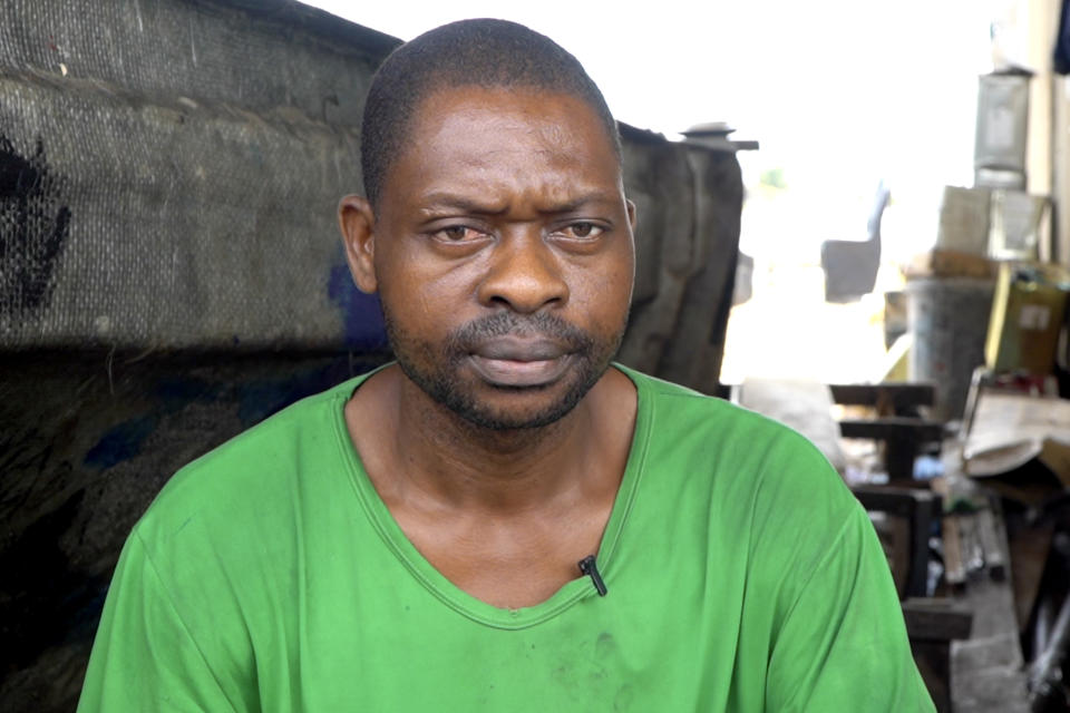 Stephen Tunlese, who lost his house and shop due to coastal erosion, listens to a question during an interview in Ayetoro, Southwest Nigeria, Friday, April 5, 2024. Ayetoro, a coastal community more than 200 km southeast of Nigeria's business capital Lagos, has been experiencing coastal erosion for many years. But the changes have recently rapidly worsened with the community slumping into the Atlantic Ocean, leading to repeated displacements of households and businesses. (AP Photo/Dan Ikpoyi)