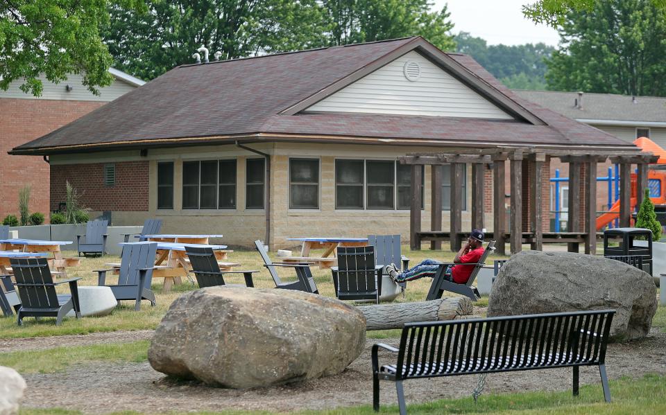 A resident relaxes in the new recreation area in Akron's Summit Lake neighborhood.