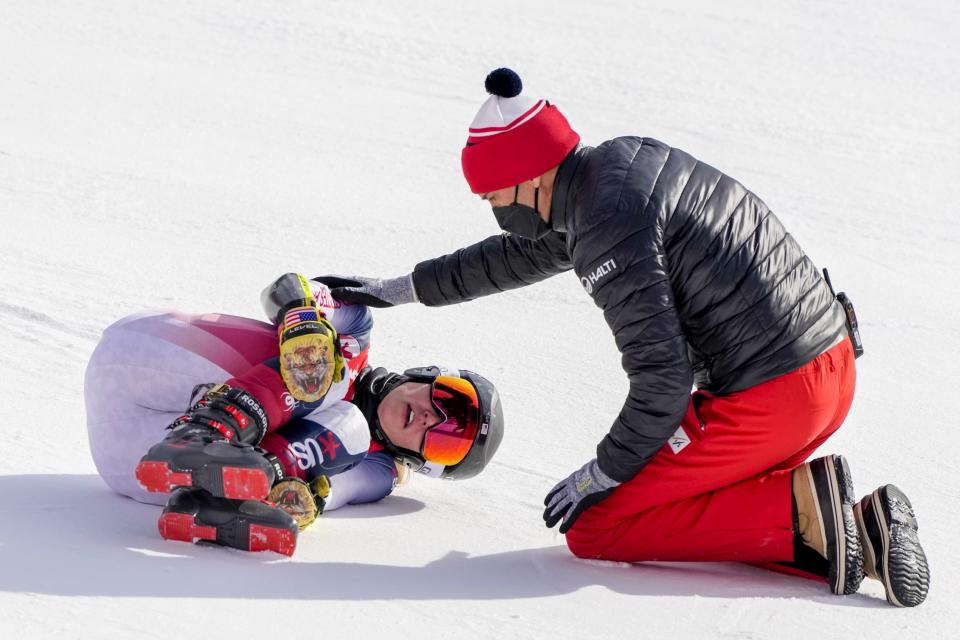 Nina O'Brien lies on the track after falling during the women's giant slalom at the 2022 Winter Olympics, Monday, Feb. 7, 2022, in the Yanqing district of Beijing.(AP Photo/Mark Schiefelbein)