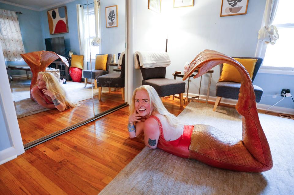 Jessica Green poses with one of her mermaid tails on at her home on Wednesday, May 31, 2023. Green used to perform as a mermaid at YMCA birthday parties but no longer does.