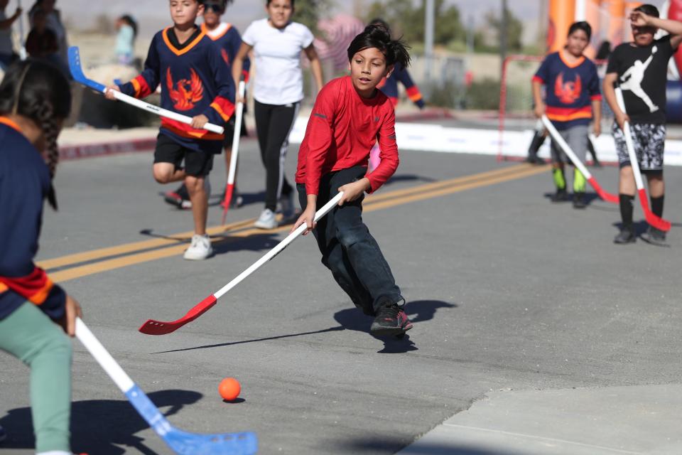 Van Buren Elementary fourth grader Izaiah Roldan competes in the Desert Sands Unified Street hockey tournament outside Acrisure Arena in Palm Desert, Calif., on Sunday, Nov. 12, 2023.