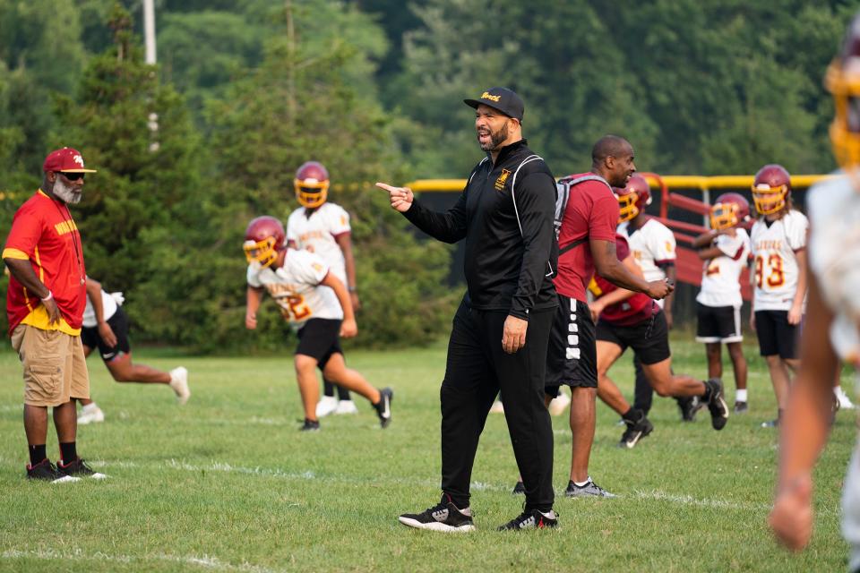 First-year Westerville North football coach Stanley Jackson Sr. leads his players during Monday's workout.