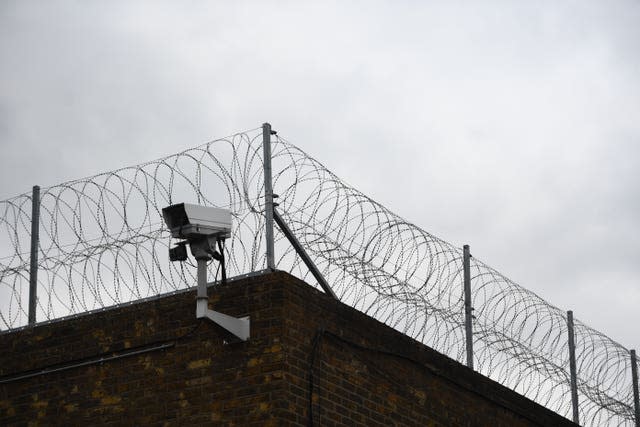 Barbed wire on a prion wall (Victoria Jones/PA)