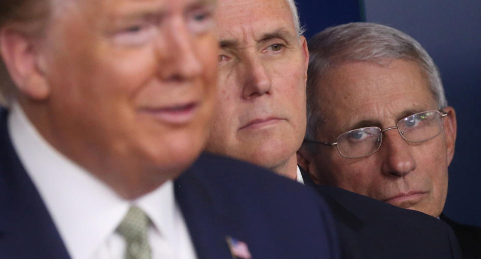 Former US President Donald Trump accompanied by Vice President Mike Pence and National Institute of Allergy and Infectious Diseases Director Anthony Fauci during the daily coronavirus briefing at the White House on March 17, 2020. Source: Reuters