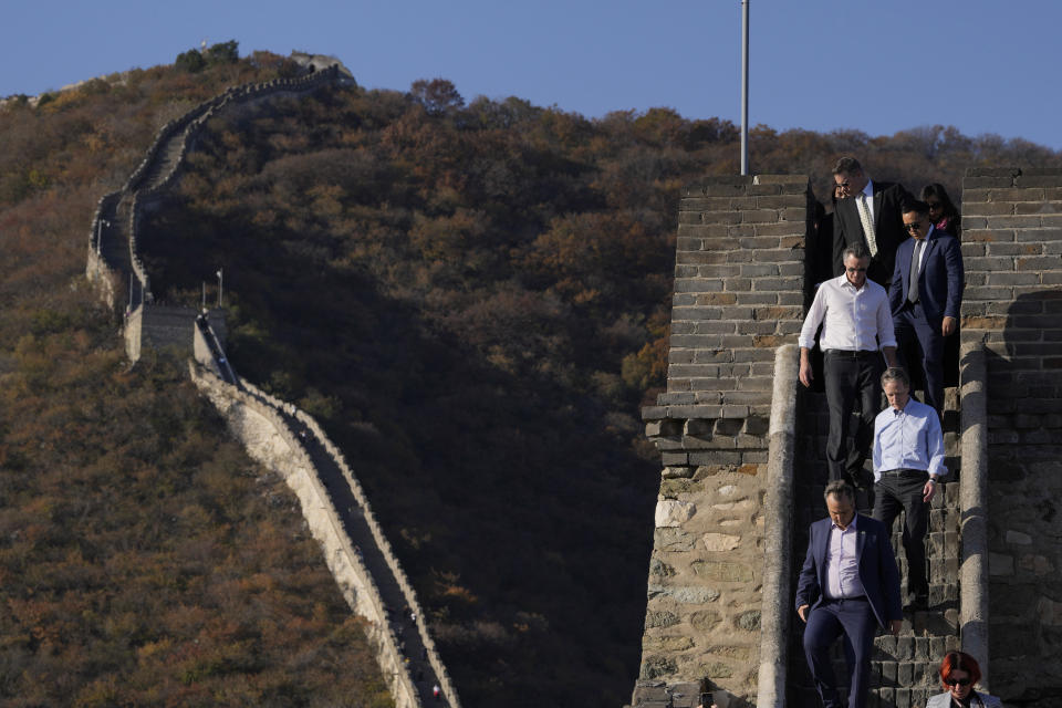California Gov. Gavin Newsom, in white shirt on the left, walks behind U.S. ambassador to China Nicholas Burns, as they visit the Mutianyu Great Wall on the outskirts of Beijing, Thursday, Oct. 26, 2023. Newsom is on a weeklong tour of China where he is pushing for climate cooperation. His trip as governor, once considered routine, is drawing attention as it comes after years of heightening tensions between the U.S. and China. (AP Photo/Ng Han Guan)