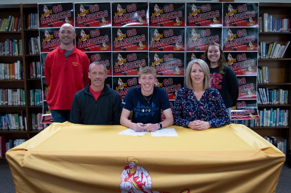 Pictured (From Left to Right): Reading boys track coach Barrie Gostlin; Reading girls track coach and Brendan's father Kurt Stump; Brendan's mother Kendra Stump and Reading cross country coach Kellie DeSchutter.