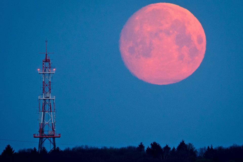 The moon goes down over the Taunus mountains near Frankfurt, Germany, early Thursday. (AP)