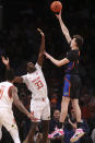 Florida's Colin Castleton shoots over Maryland's Qudus Wahab (33), of Nigeria, during the first half of an NCAA college basketball game Sunday, Dec. 12, 2021, in New York. (AP Photo/Jason DeCrow)