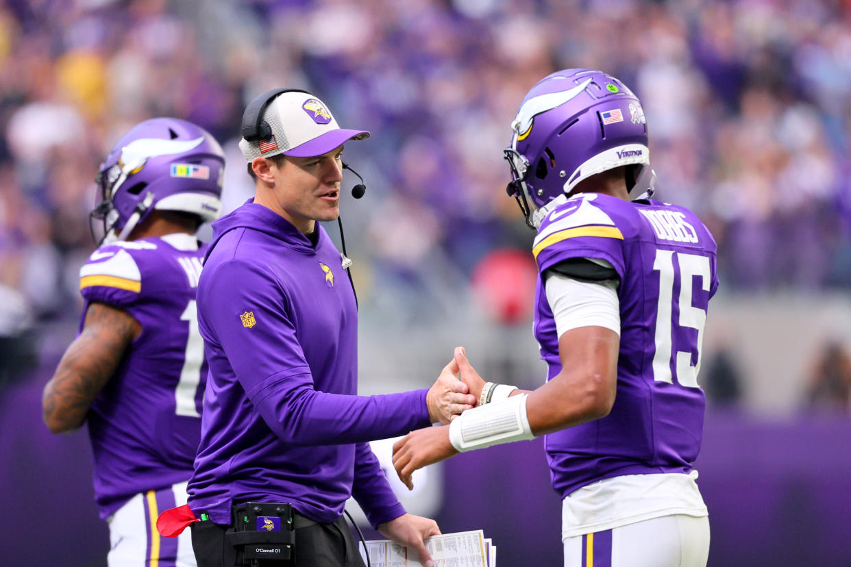 Vikings coach Kevin O'Connell of the Minnesota Vikings congratulates Joshua Dobbs during Sunday's game against the Saints. (Photo by Adam Bettcher/Getty Images)