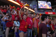 Spanish fans cheer in front of large screens after Spain's Olga Carmona scored the opening goal during the Women's World Cup final soccer match between Spain and England in Madrid, Spain, Sunday, Aug. 20, 2023. (AP Photo/Paul White)