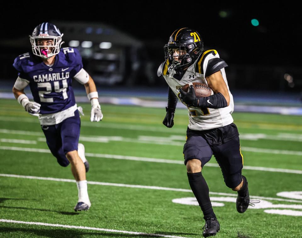 Newbury Park's Shane Rosenthal is off and running as Camarillo's Brandon Contreras pursues during the teams' Canyon League game on Friday, Oct. 28, 2022. Camarillo won 26-14 to secure second place in league. Both teams qualified for the postseason.