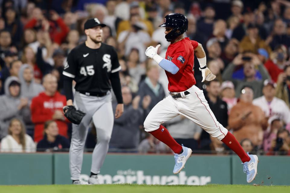 Boston Red Sox's Ceddanne Rafaela, right, scores on a sacrifice fly by Adam Duvall off Chicago White Sox relief pitcher Garrett Crochet (45) during the eighth inning of a baseball game, Friday, Sept. 22, 2023, in Boston. (AP Photo/Michael Dwyer)