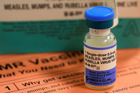 FILE PHOTO: A vial of measles, mumps and rubella vaccine and an information sheet is seen at Boston Children's Hospital in Boston, Massachusetts February 26, 2015. REUTERS/Brian Snyder/File Photo